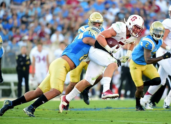 PASADENA, CA - SEPTEMBER 24:  Christian McCaffrey #5 of the Stanford Cardinal is tackled by Josh Woods #19 of the UCLA Bruins on a run during the first quarter at Rose Bowl on September 24, 2016 in Pasadena, California.  (Photo by Harry How/Getty Images)